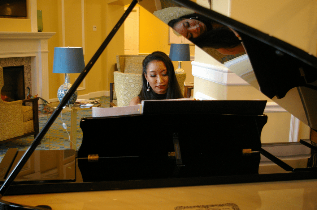 Deanna L. Giron - Singer & Pianist playing the piano
