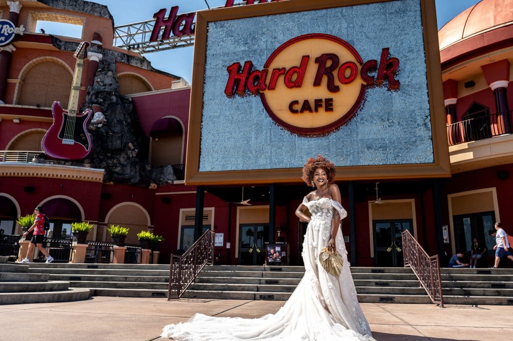 Woman in her bridal gown standing in front of the Hard Rock Cafe in Orlando