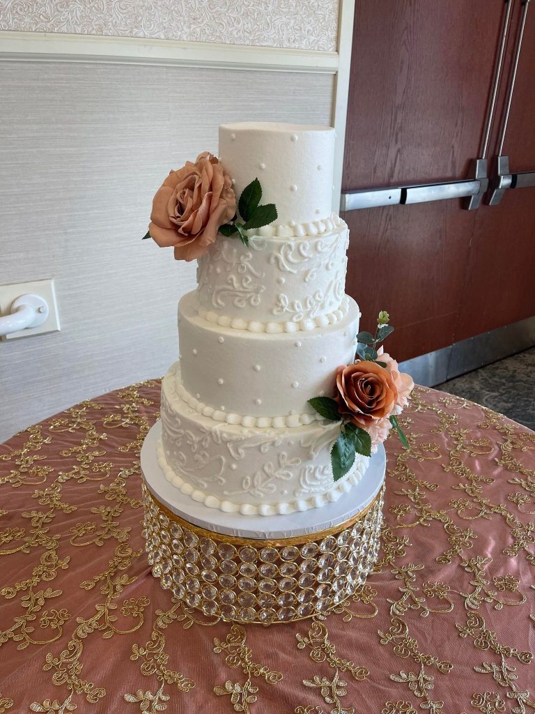 classic and elegant white tiered wedding cake with burnt umber flowers by Cake & Bake