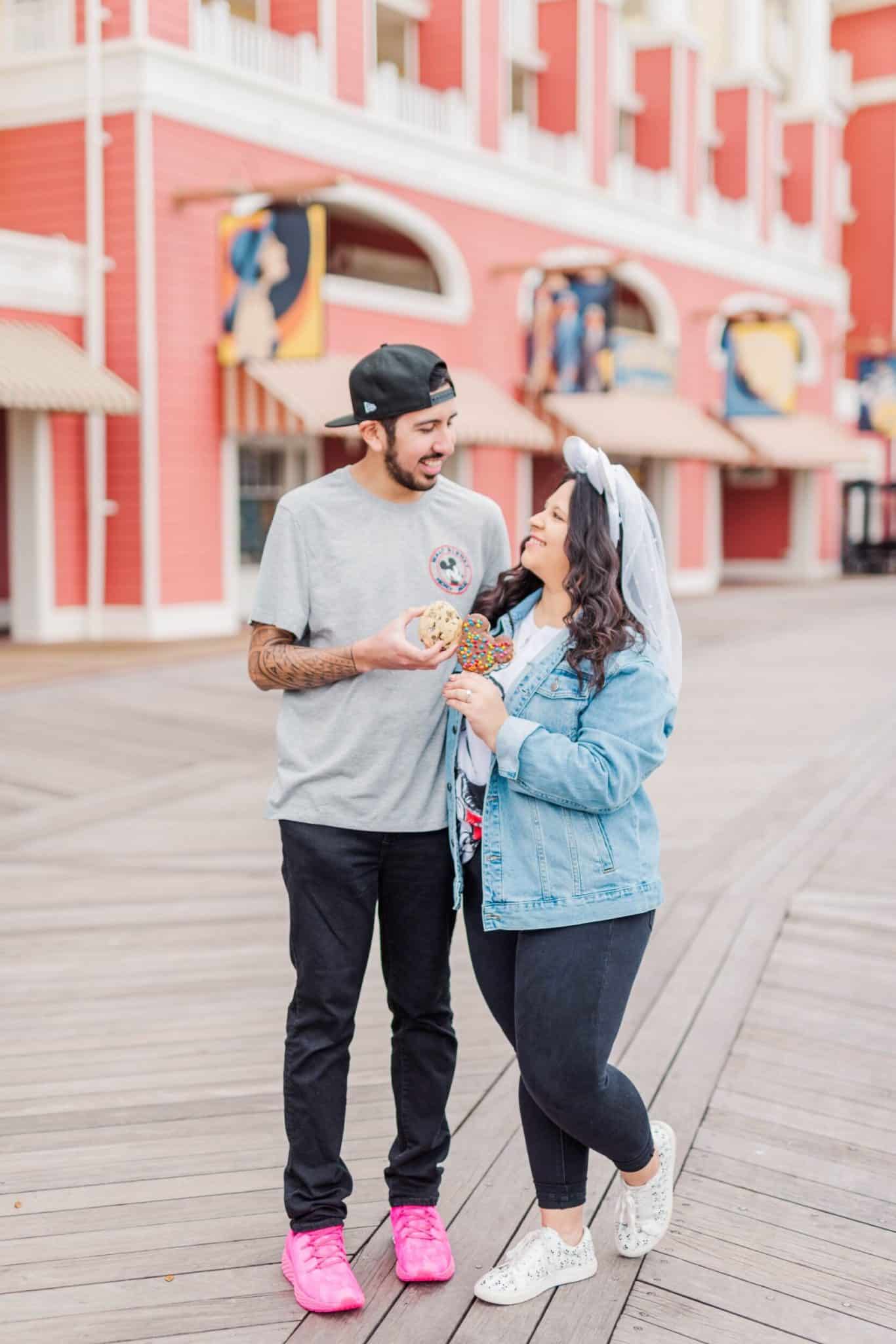 Newly engaged couple at Disney World holding Mickey Mouse Ice creams