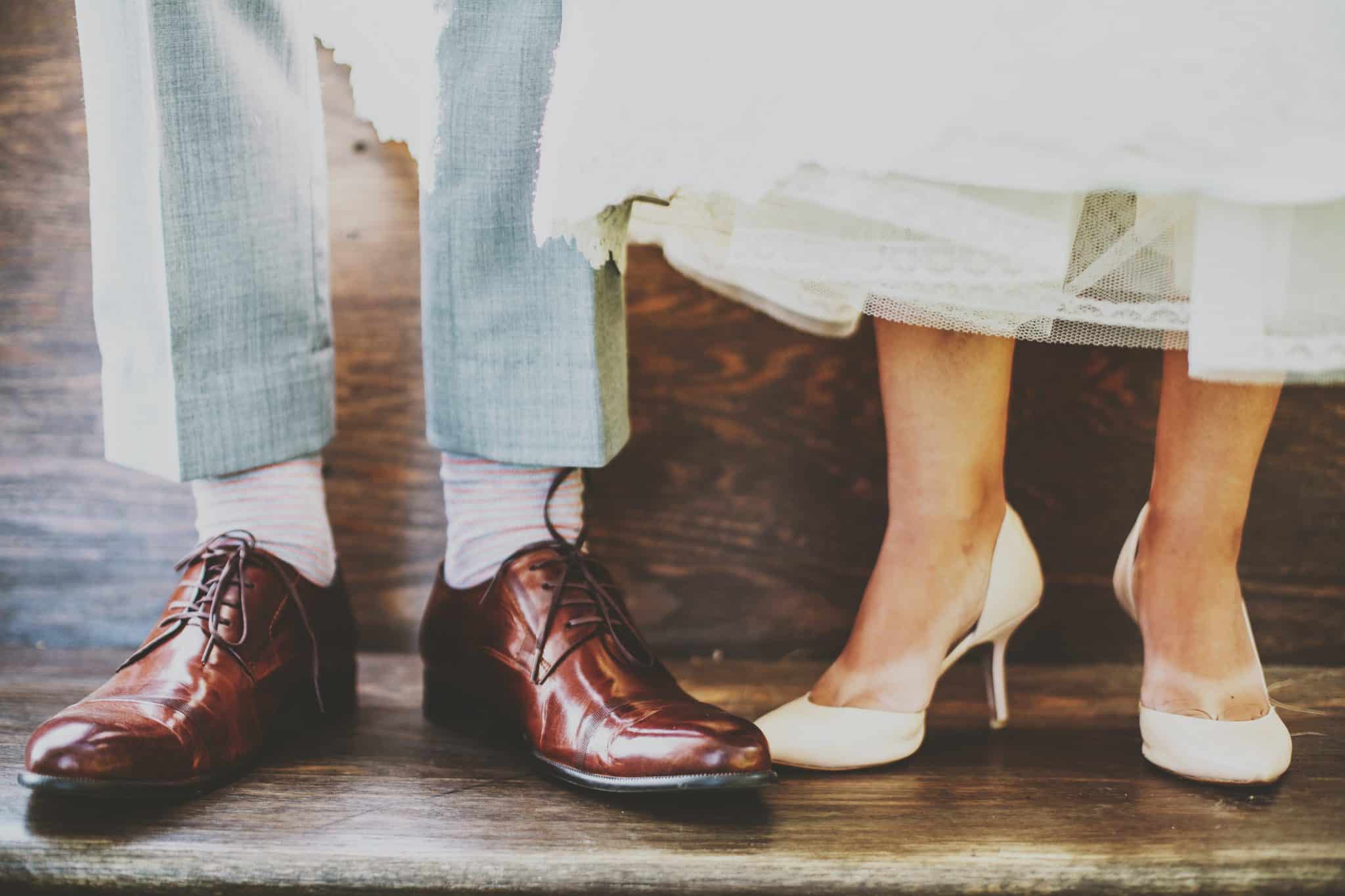 close up photo of bride and groom's wedding day shoes