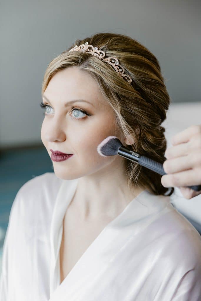 bride having her makeup done by Marci Knuth Hair And Makeup LLC