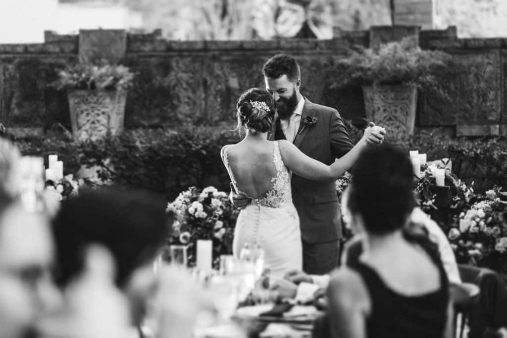 black and white photo of bride and groom dancing at outdoor wedding photographed by Ashley Jane Photography