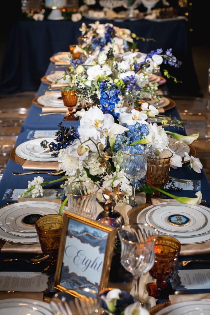 tablescape in blues and whites with blue and white flowers from Dream Design Florist