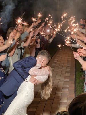 sparkler exit of groom dipping bride at the end of brick path at the Rocking L Ranch Wedding Barn