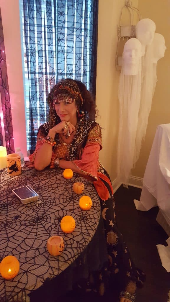 The Psychic Lady waiting at candlelit table for first guest