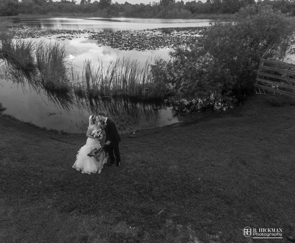 black and white drone photo of bride and groom kissing at the Rocking L Ranch Wedding Barn