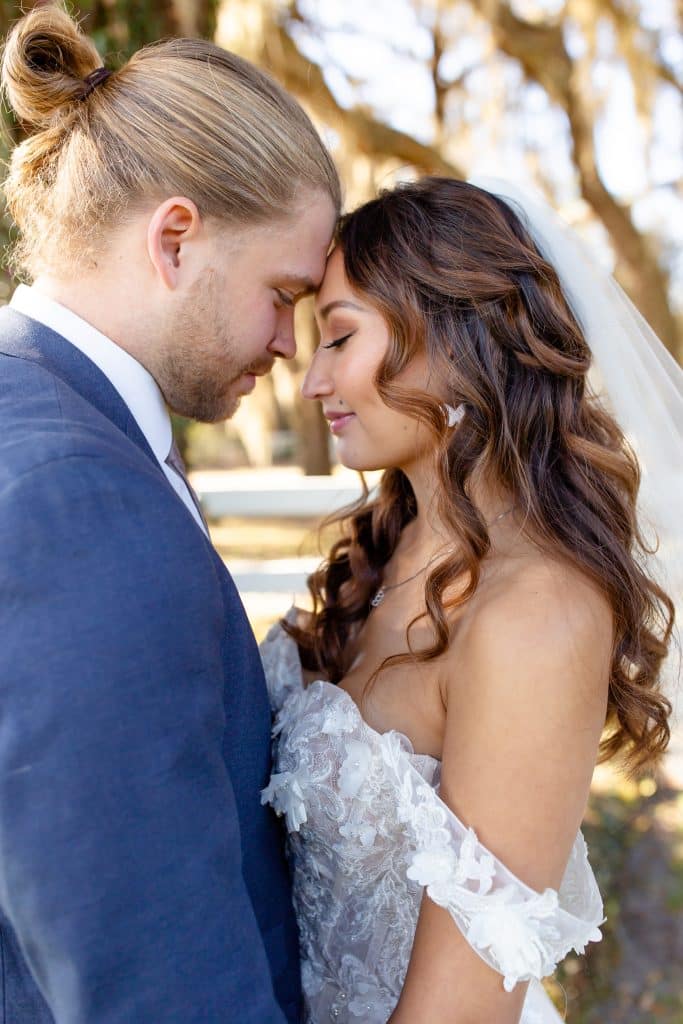 bride and groom with long hair by Marci Knuth Hair And Makeup LLC having a quiet embrace