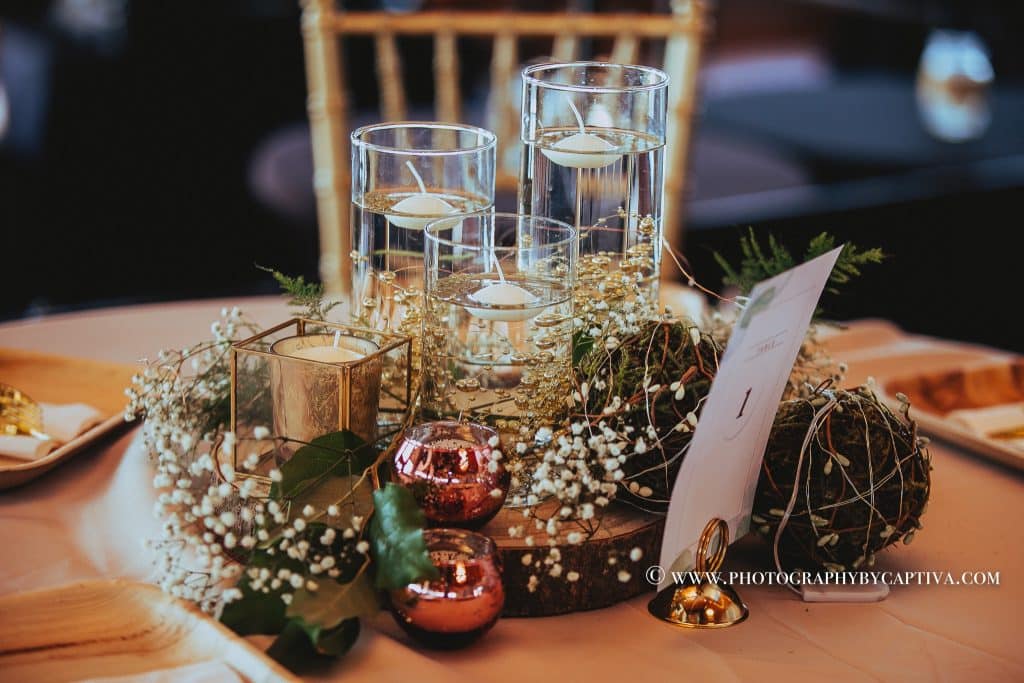 holiday centerpiece with baby's breath, gold candles and red ornaments at 520 on the Water