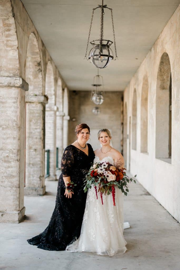 bride and her mother standing in outdoor walkway with hair and makeup by Marci Knuth Hair And Makeup LLCkeup