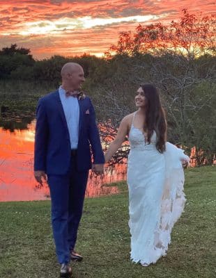 bride and groom walking at sunset at the Rocking L Ranch Wedding Barn