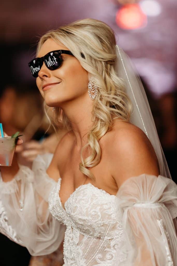 bride wearing her sunglasses at night on the dance floor to music provided by COS Celebrations