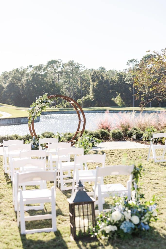 outdoor wedding ceremony site with wooden arch altar at St. Johns Golf & Country Club