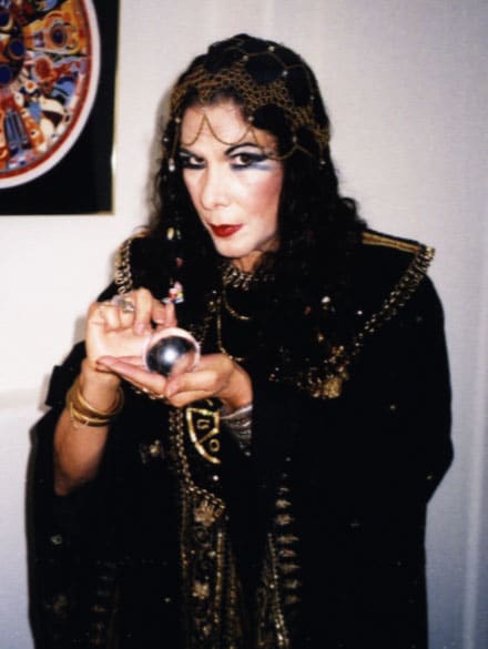 The Psychic Lady holding black orb in her hands dressed in black