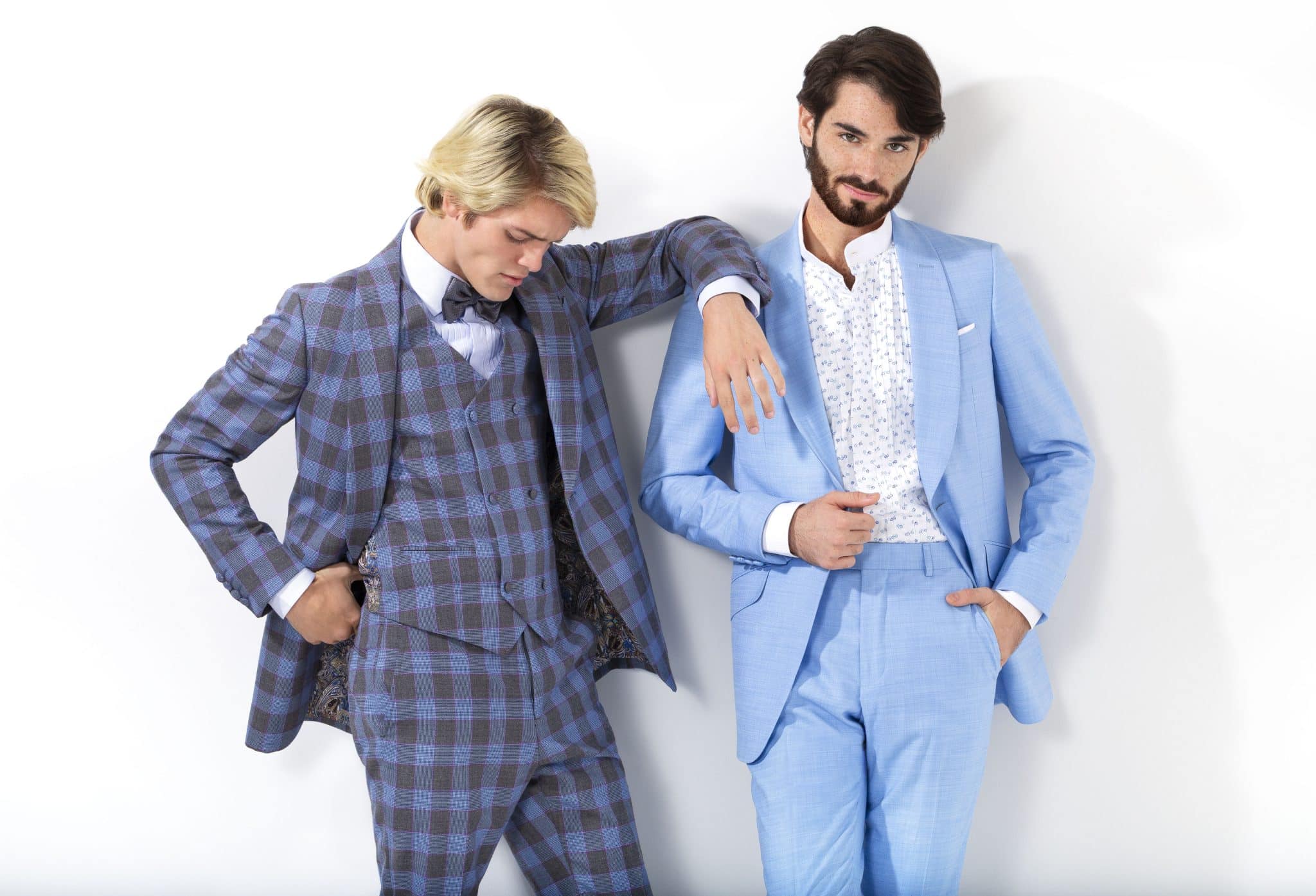 Two gentlemen model Leonardo 5th Avenue modern men's suits and tuxedos in blue checkered pattern and light blue solid colors. 