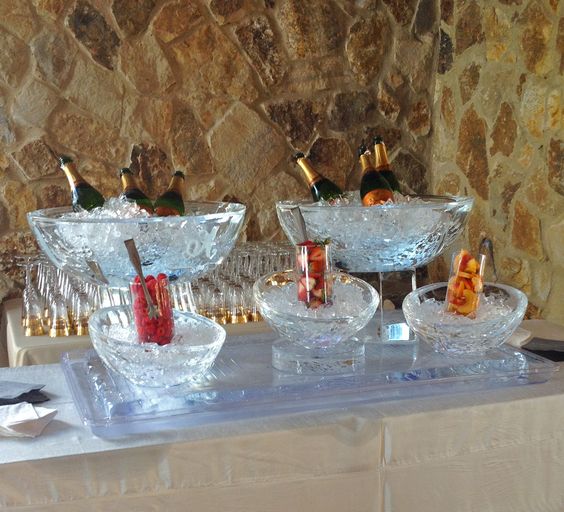 ice bowls holding wine and champagne carved by Ice Pro
