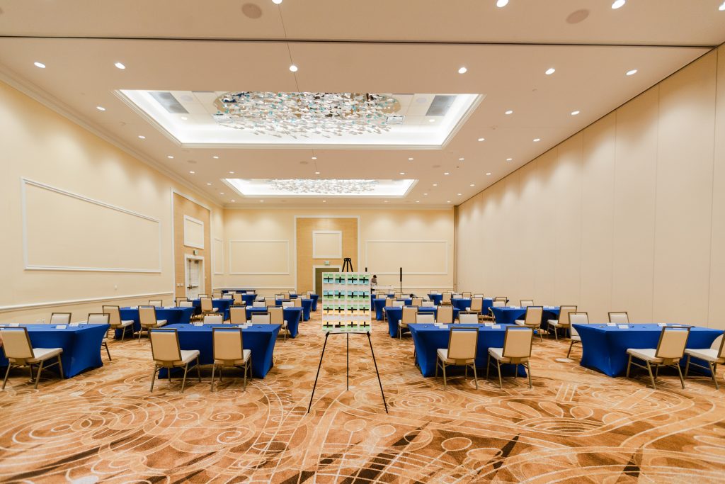 event space at Margaritaville Resort Orlando with tables setup with blue linen and sign in the middle of the room