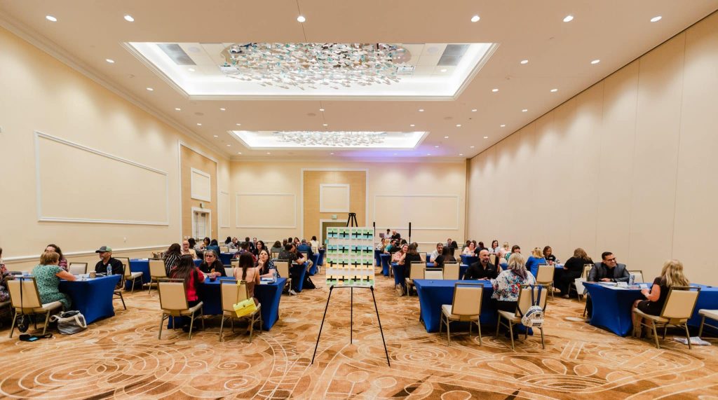 room setup with tables and guests having a speed networking event