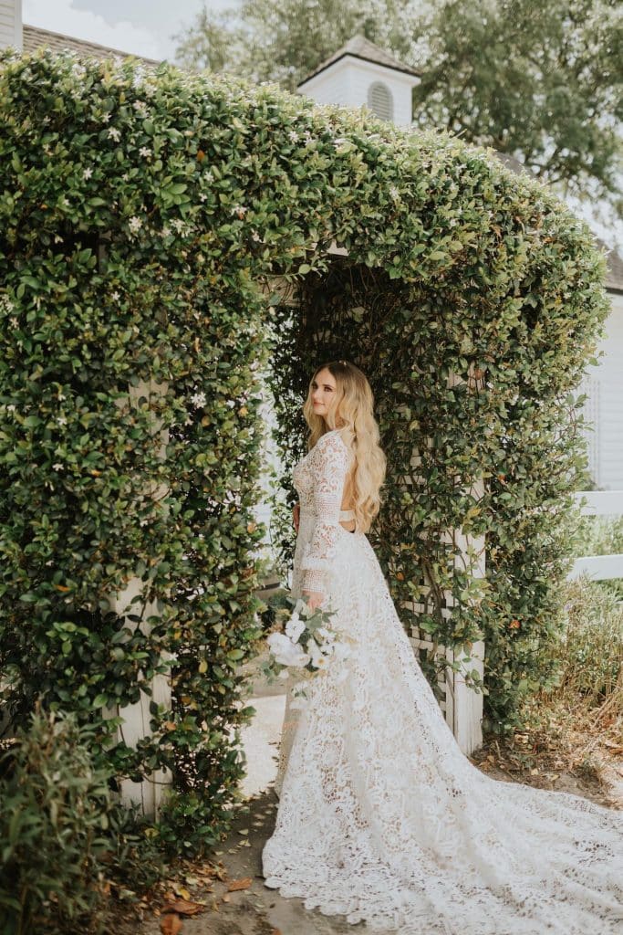 bride against ivy covered wall at wedding planned by The Lainey Rose
