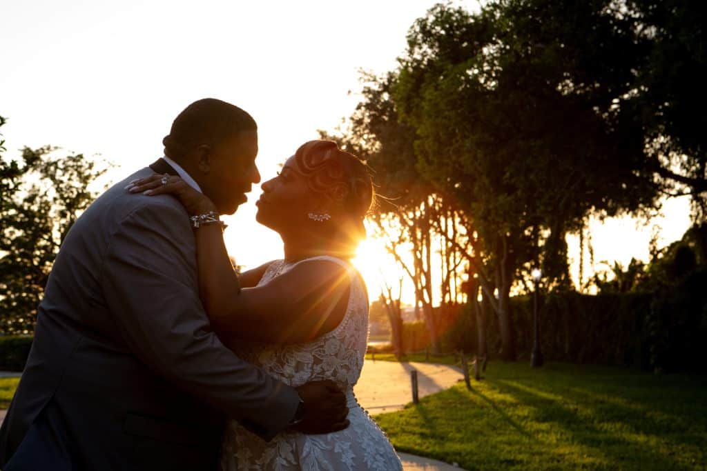 bride and groom silhouetted against setting sun at wedding planned by The Lainey Rose