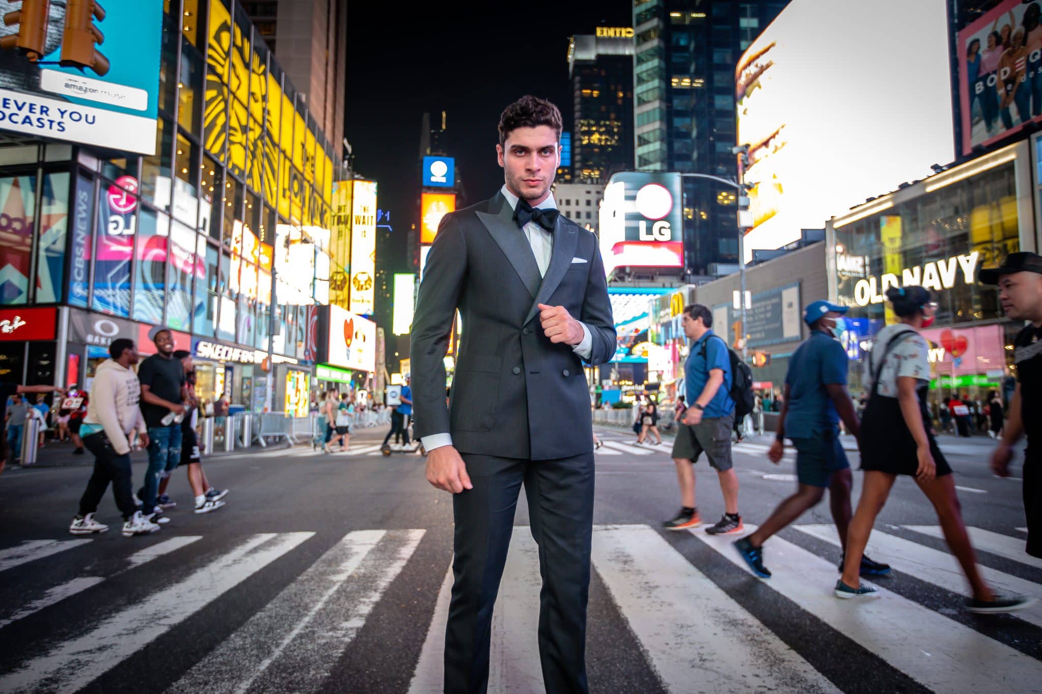 Modern man stand in city street modeling Leonardo 5th Avenue black tuxedo