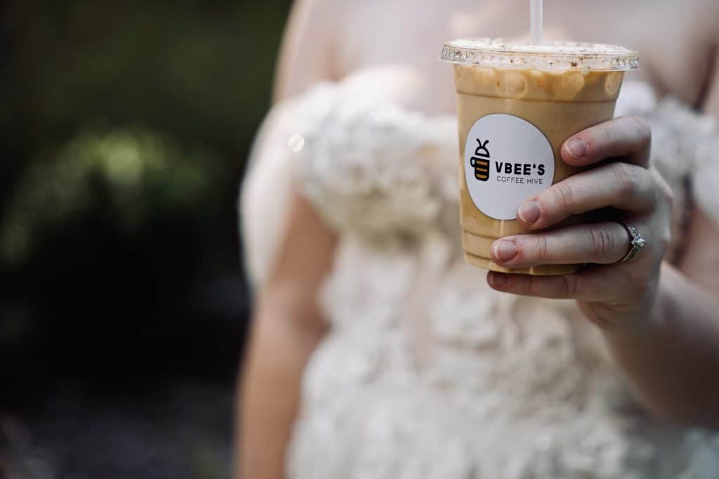 bride holding VBee’s Coffee Hive cup of iced coffee