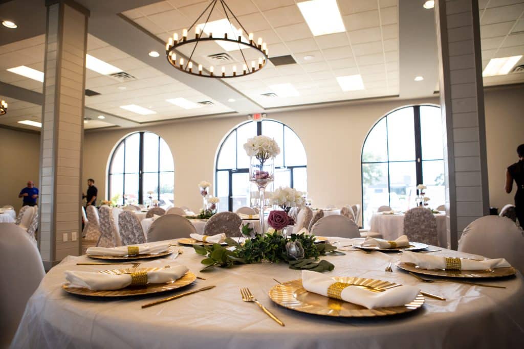 wedding reception room ready with gold chargers at wedding planned by The Lainey Rose