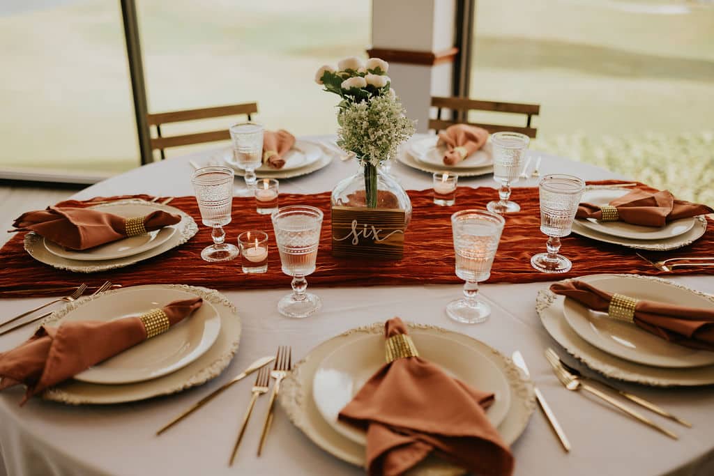 colorful tablescape in ombre tones of red at wedding planned by The Lainey Rose