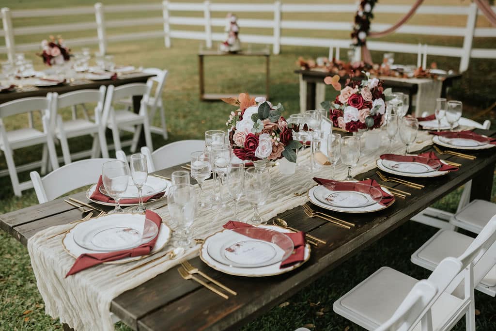 table setting with pink and rose accents at wedding planned by The Lainey Rose