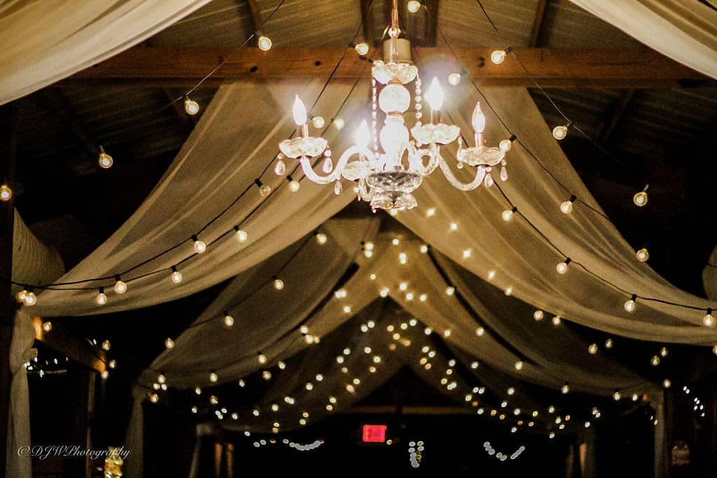 at the Rocking L Ranch Wedding Barn swagged ceiling with market lights