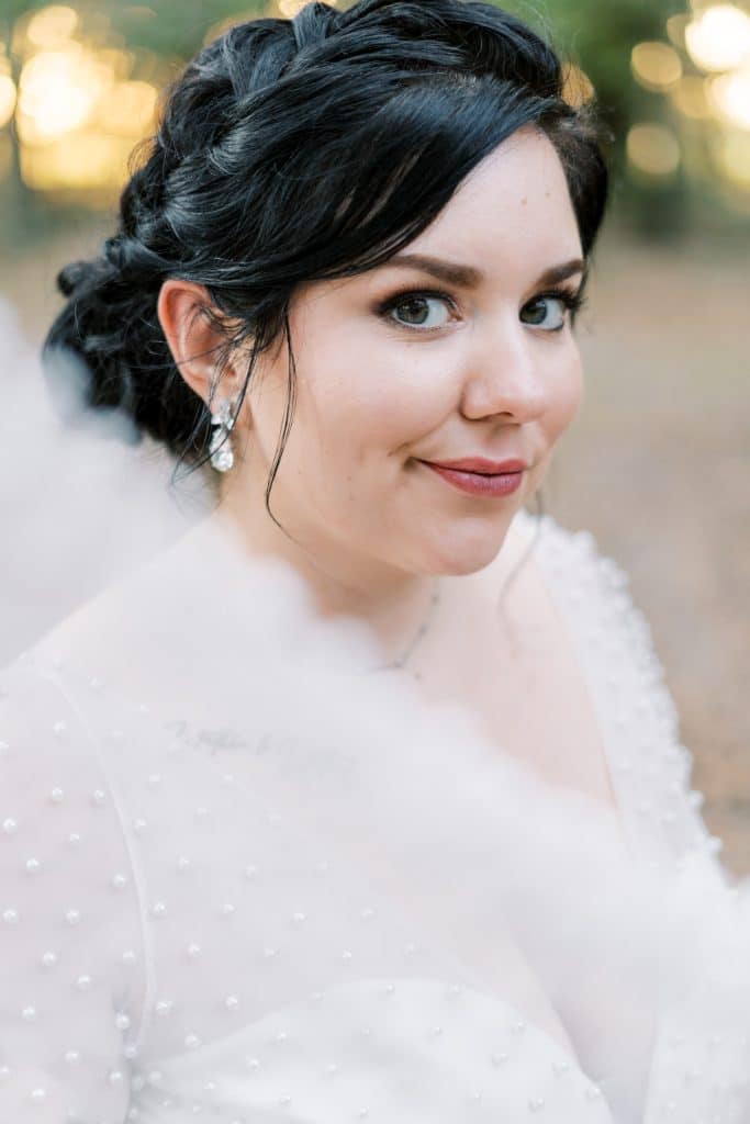 bride with braided hair and natural makeup by Marci Knuth Hair And Makeup LLC