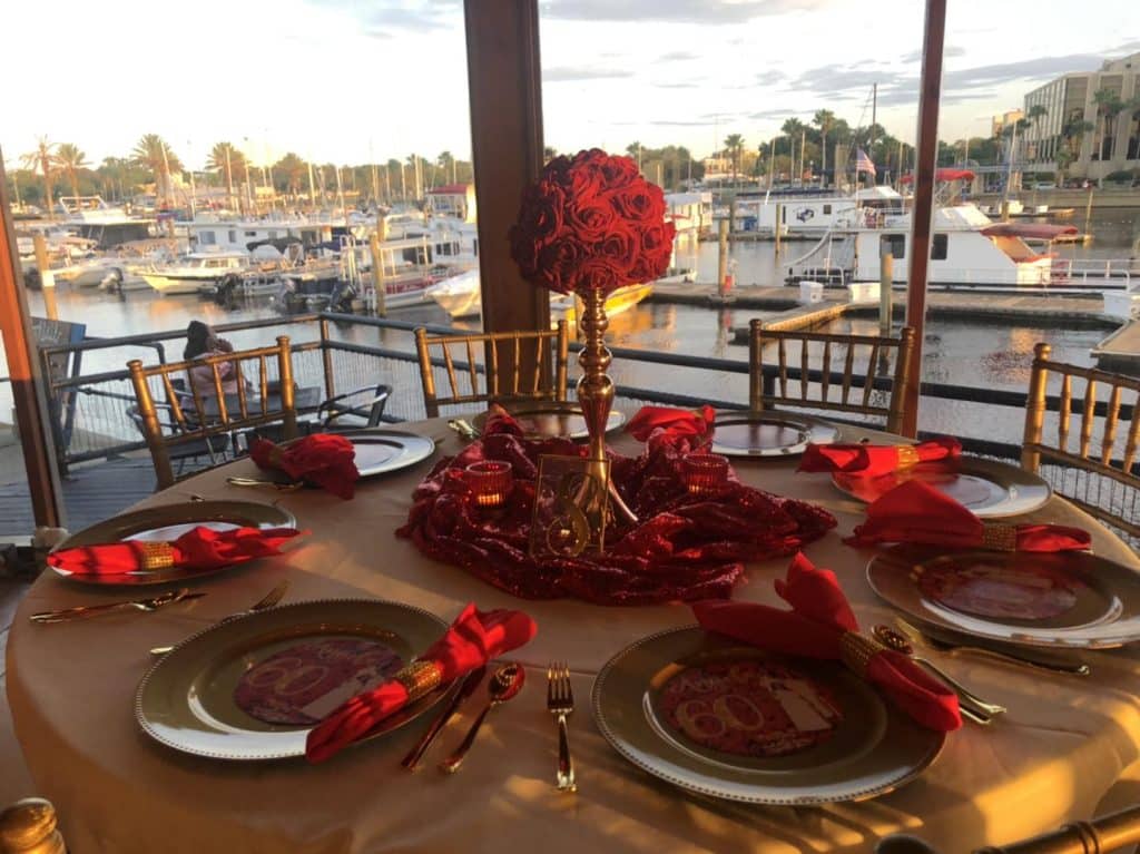 table set with gold and red accents looking out at the marina at 520 on the Water