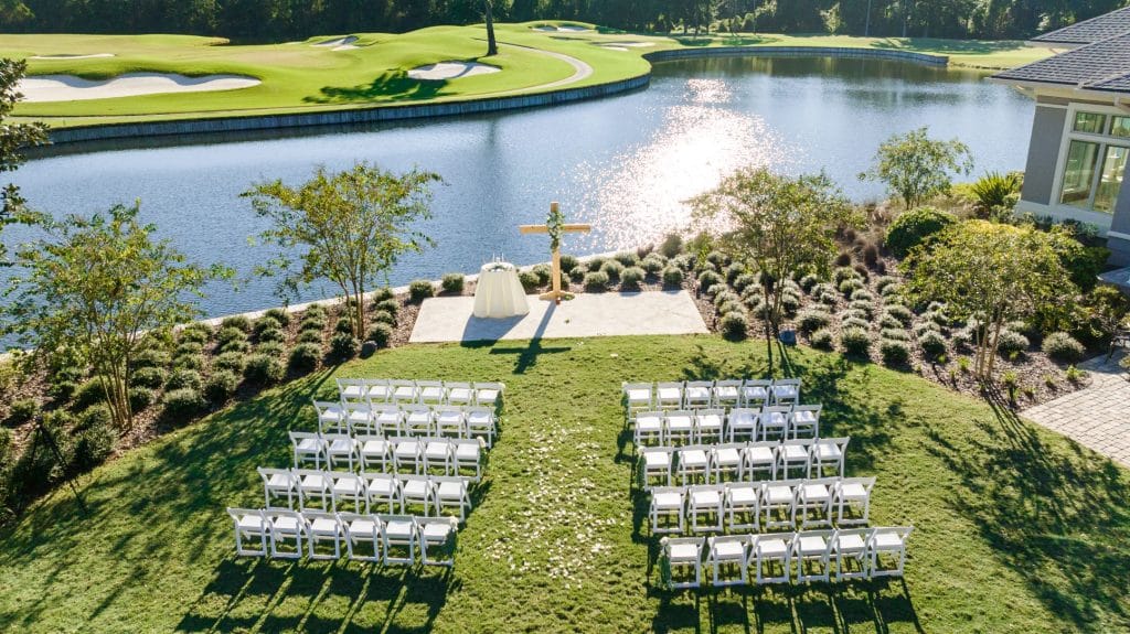 view down to wedding ceremony site with lake in the background in front of golf green at St. Johns Golf & Country Club
