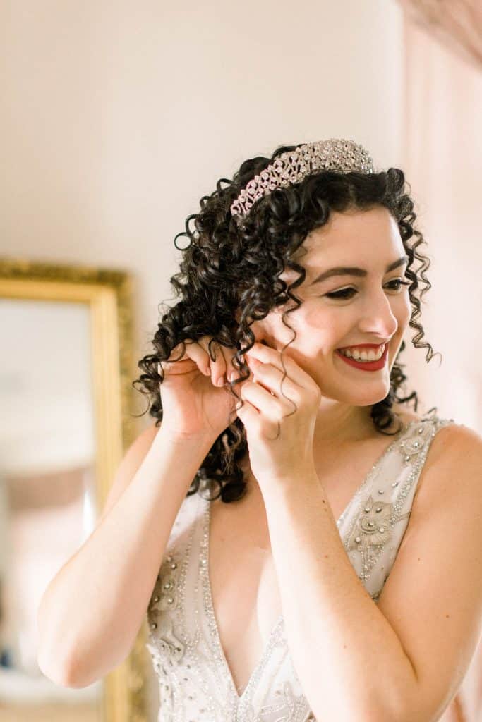 bride with tiara in her curls and red lipstick by Marci Knuth Hair And Makeup LLC