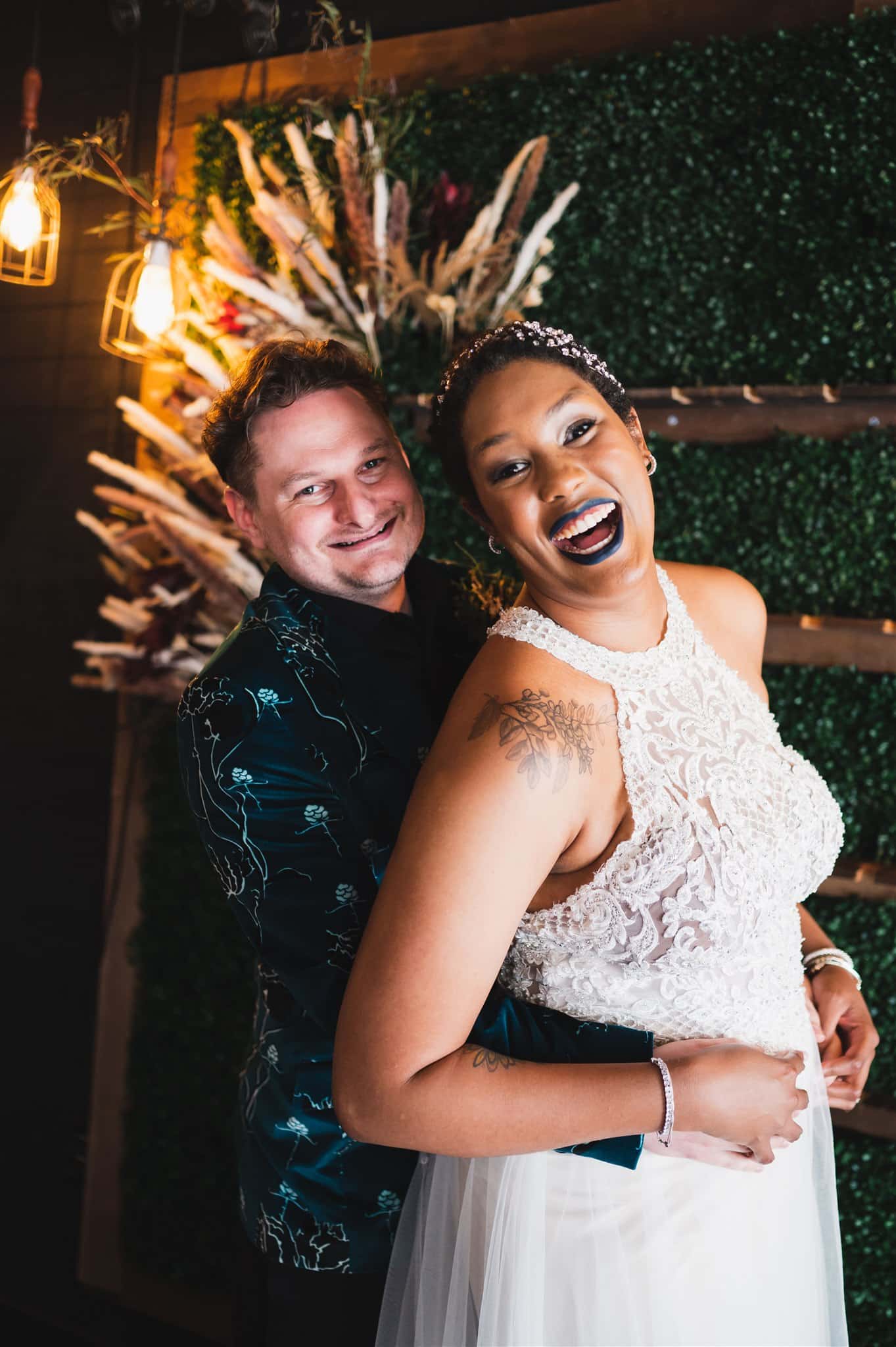 Newlyweds, Melody and Steven smile happily after their unique and stylish wedding at Trellis 925 in Central Florida. 