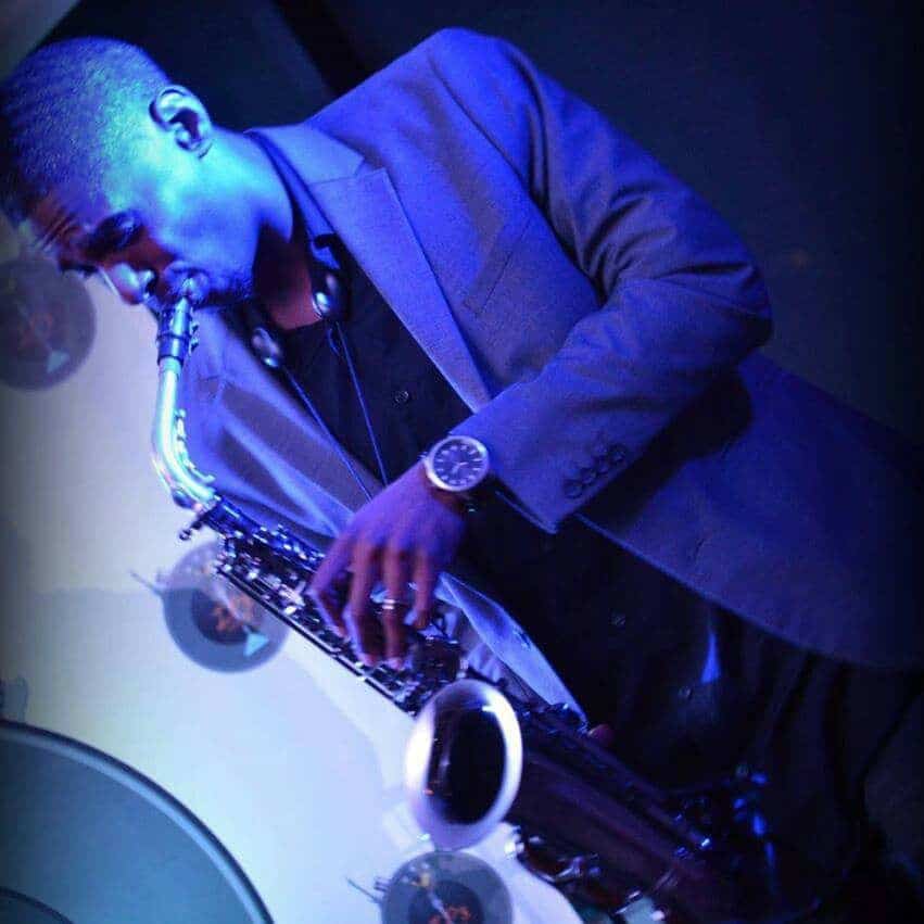 Khalil Stultz Saxophonist in blue light playing his horn