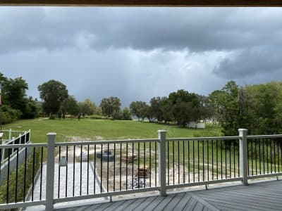 Outdoor view from the balcony, of the sky and trees that line the property, Ballroom on the Lake, Central, FL