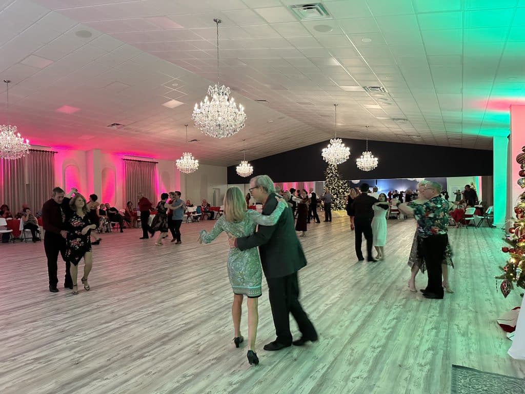 Ballroom decorated for the holidays, guests dancing and enjoying a holiday party, Central, FL