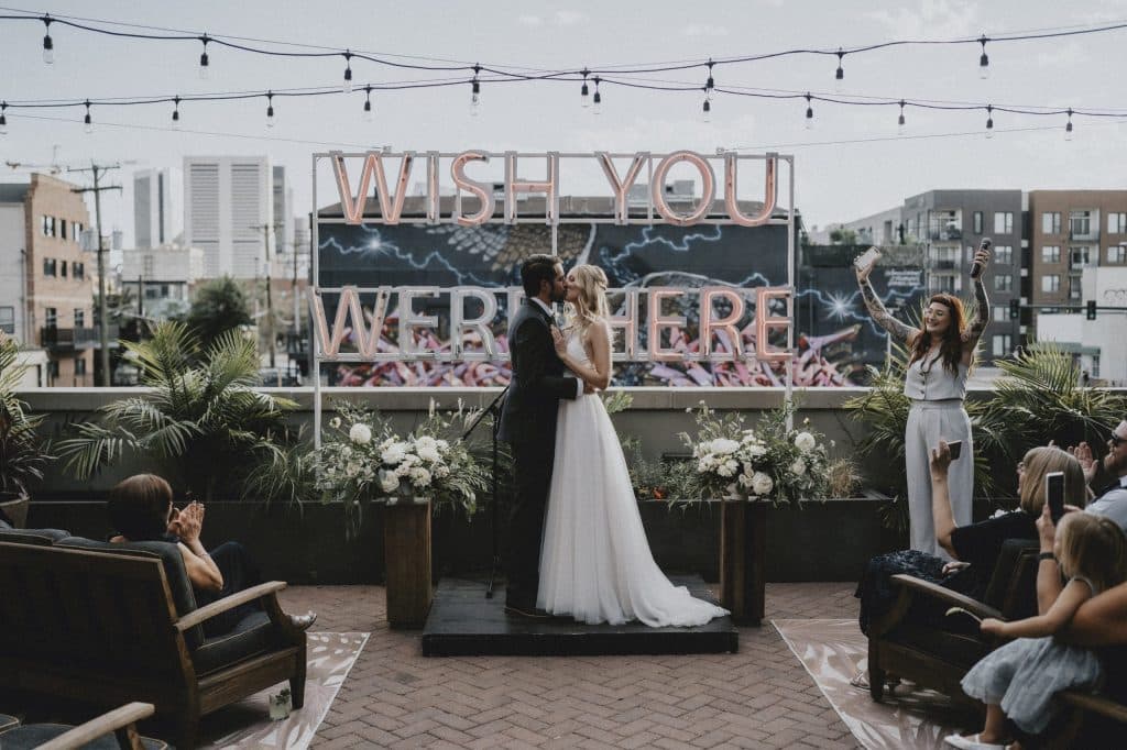 wish you were here sign backdrop at a rooftop wedding ceremony by Torontali Photography an Orlando wedding photographer