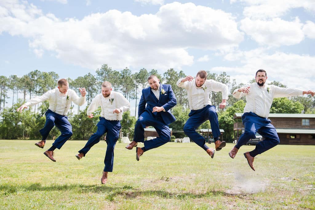 groom and groomsmen all jumping photographed by Hundreds of Moments Photography