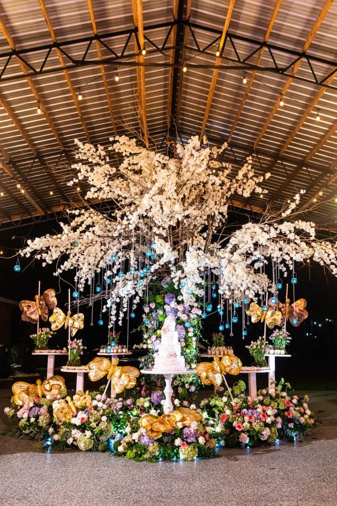 large centerpiece under a metal roof by Elite Celebrations