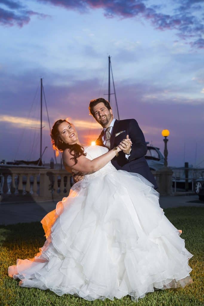 groom dipping bride at sunset by Evan Hampton Photography