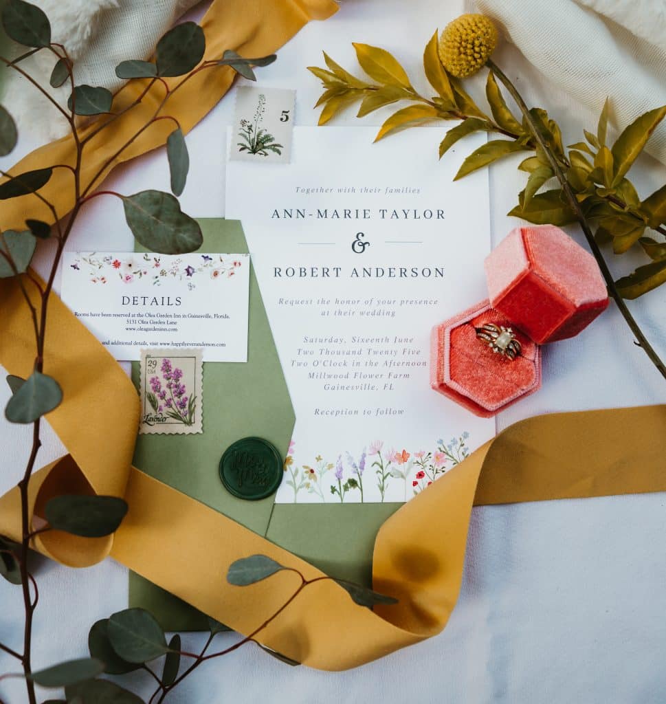 Flatlay of ring, invitation and florals in Orlando, FL by Sunshine Memories Photography