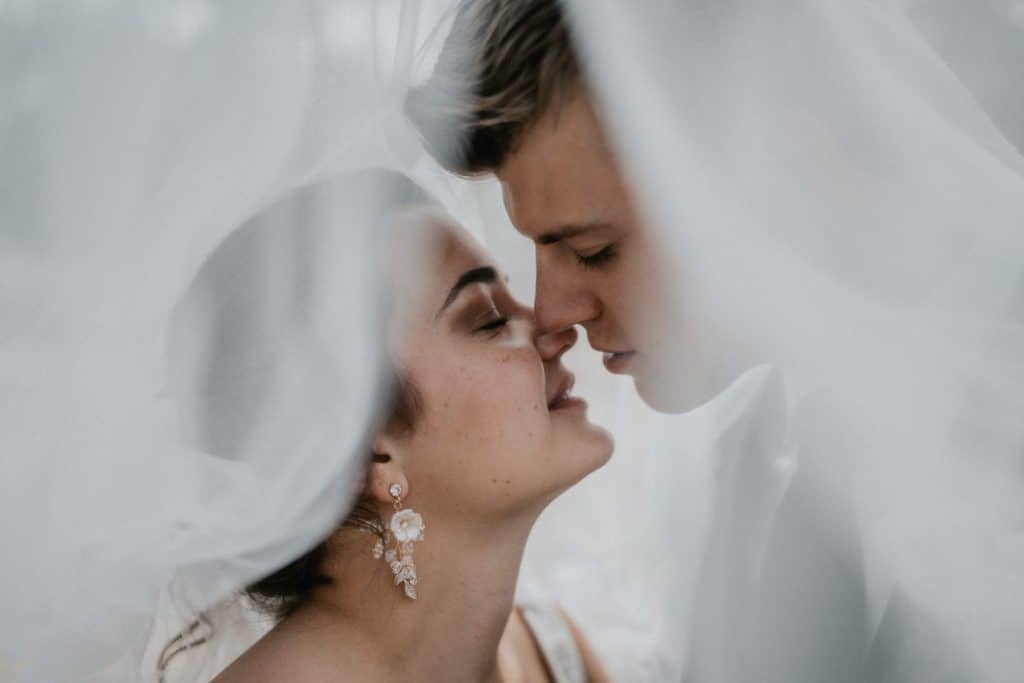 picture of bride and groom almost kissing under the veil by Torontali Photography an Orlando wedding photographer