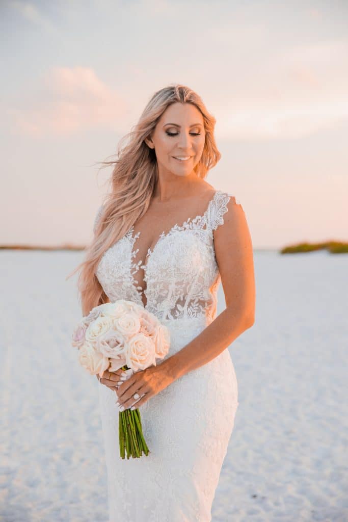 bride on white sand beach photographed by Slone Photography, LLC