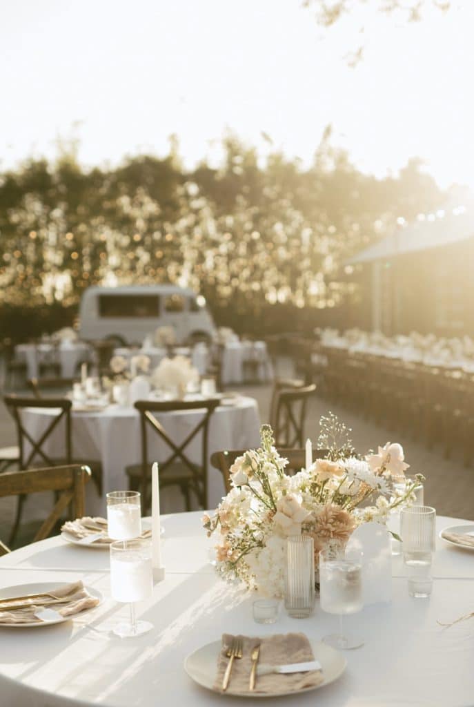 wedding reception table in white at sunset from Echo Event Rentals