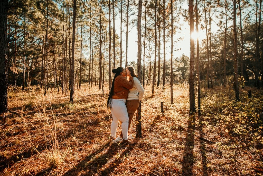 Wide shot of engagement shoot in the woods in Orlando, FL