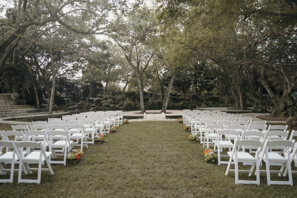 outdoor wedding ceremony site with white chairs at wedding coordinated by A. Marie Events & Design