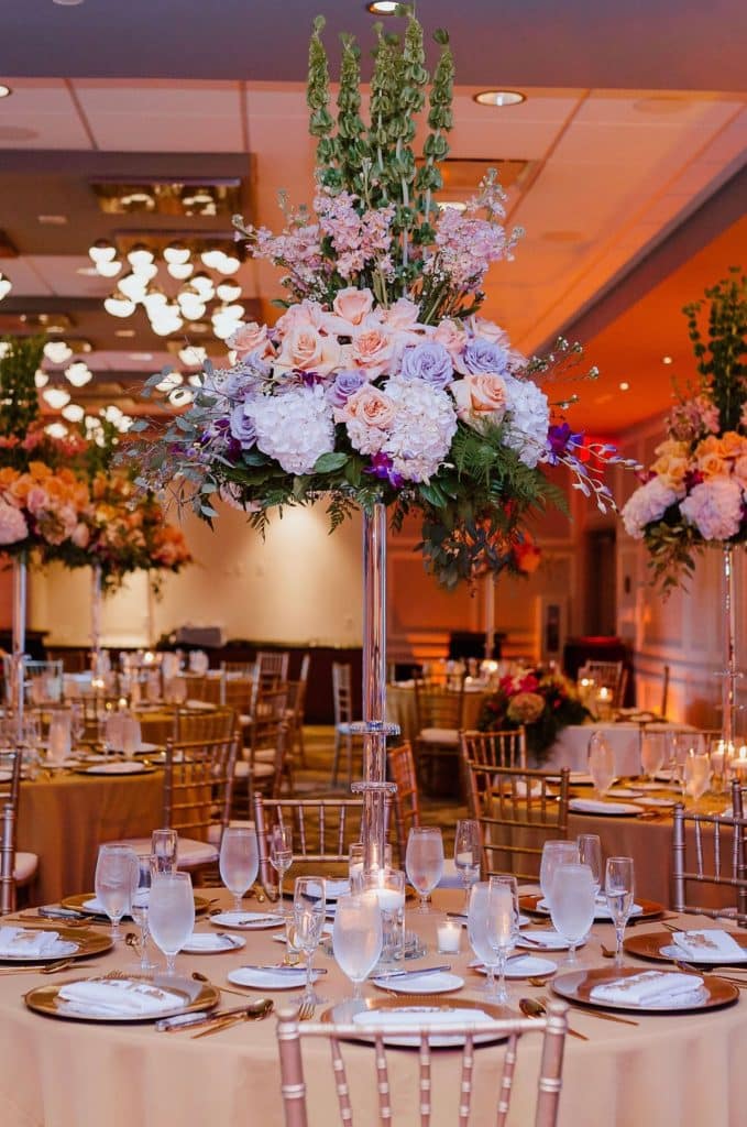 tall centerpieces of blue, white and blush flowers at event by Elite Celebrations
