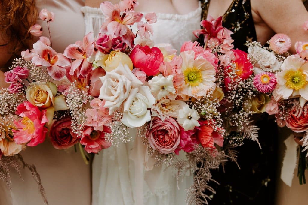 ombre shades of pinks, oranges and white wedding bouquets from In Bloom Florist